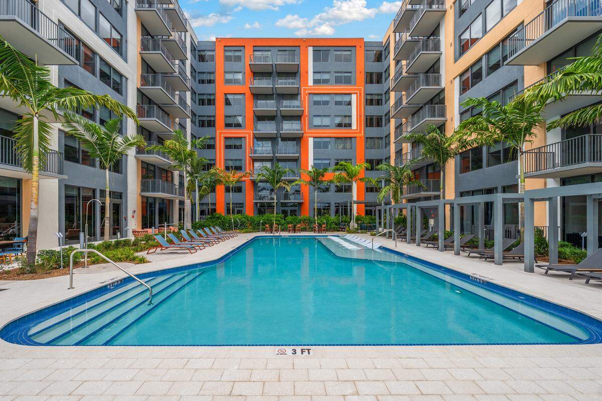 A big swimming pool is surrounded by the Centro City apartments in western Little Havana. The 400 market-rate but affordable apartments, developed by Terra Group and designed by Miami’s Arquitectonica, are tucked behind a strip shopping mall.