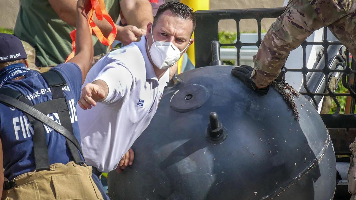 A naval bomb, approximately four feet in diameter, washed ashore on the sand near Lauderdale by the Sea Sunday morning. It was labeled “INERT”, but it could have been used for military training and might have been live at one point. A BSO bomb squad worked to move it from the beach to an unknown location. The photos were taken near the Pine Avenue portal, at the north end of El Mar Drive, adjacent to the Plunge Beach Hotel.