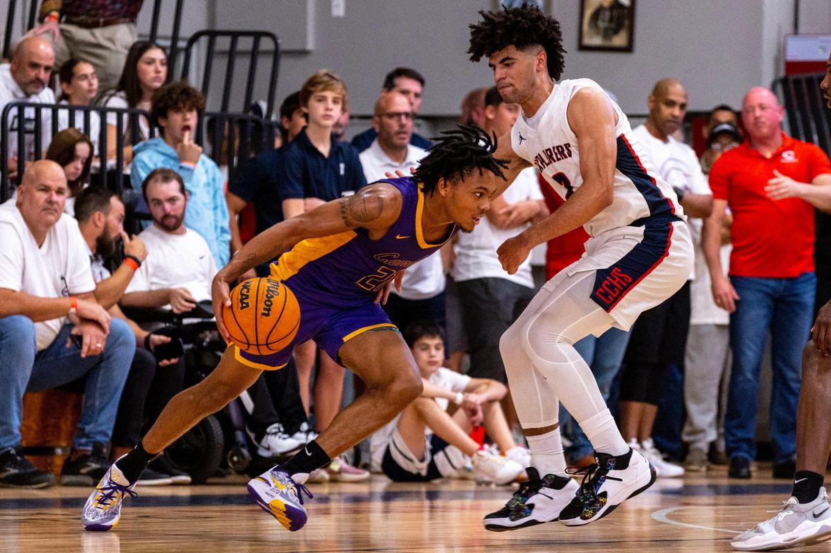 Camden guard DJ Wagner (21) drives on Explorers guard Cayden Boozer (2)during the fourth period of a high school basketball game at Christopher Columbus High School in Miami, Florida, on Wednesday, January 4, 2023.