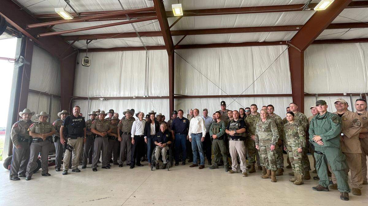 Florida Gov. Ron DeSantis, Texas Gov. Greg Abbott take a photo with law enforcement officials who have participated in the Texas border mission.
