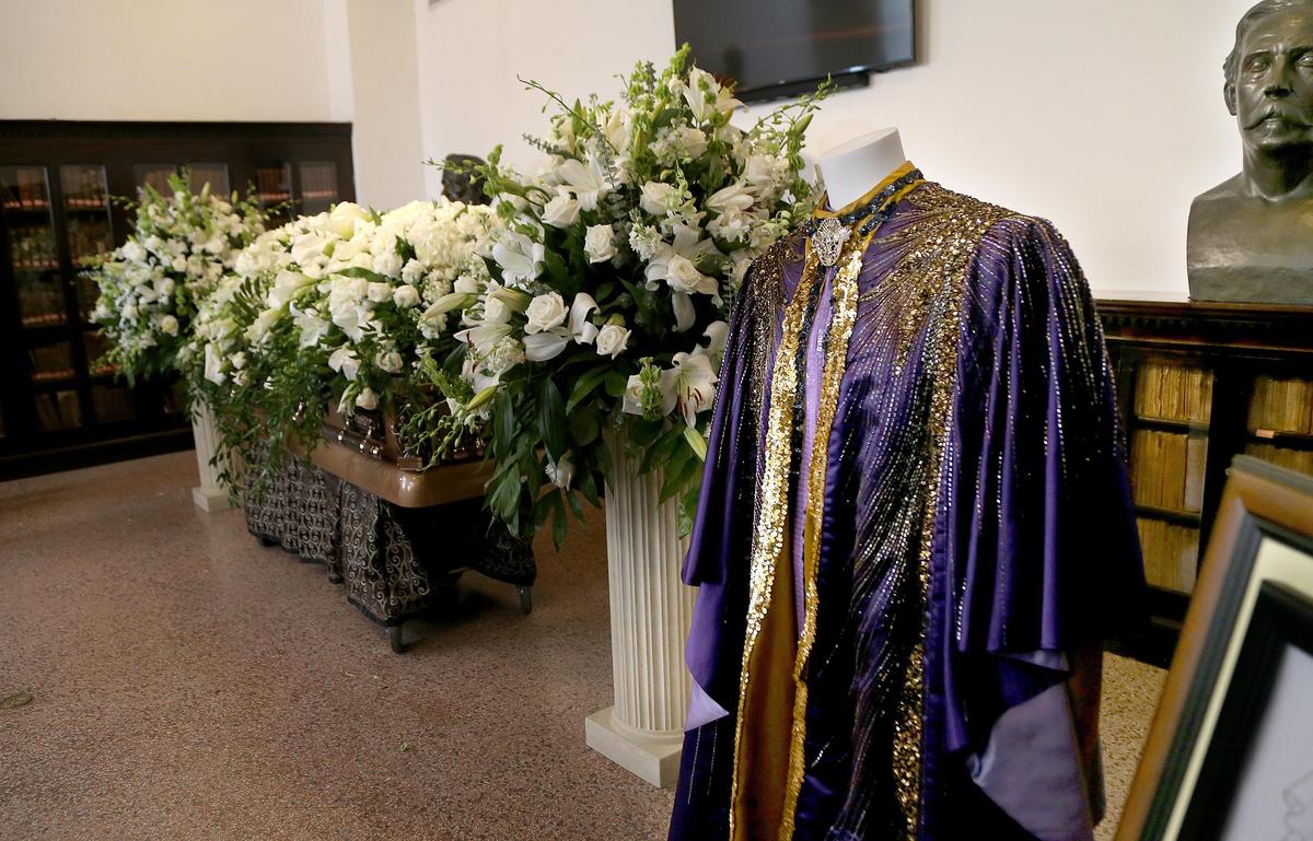 A cape worn by celebrity astrologer Walter Mercado hangs next to his casket inside the Ateneo Puertorriqueño cultural center in Old San Juan on Thursday, Nov. 7, 2019.