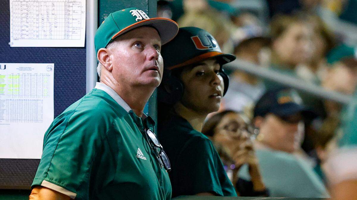 Miami Hurricanes head coach Gino DiMare keeps an eye on a fly ball to right field during the game against Maine in the first round of the Coral Gables Regional of the NCAA Division I Baseball Championship at Alex Rodriguez Park at Mark Light Field in Coral Gables on Friday, June 2, 2023.