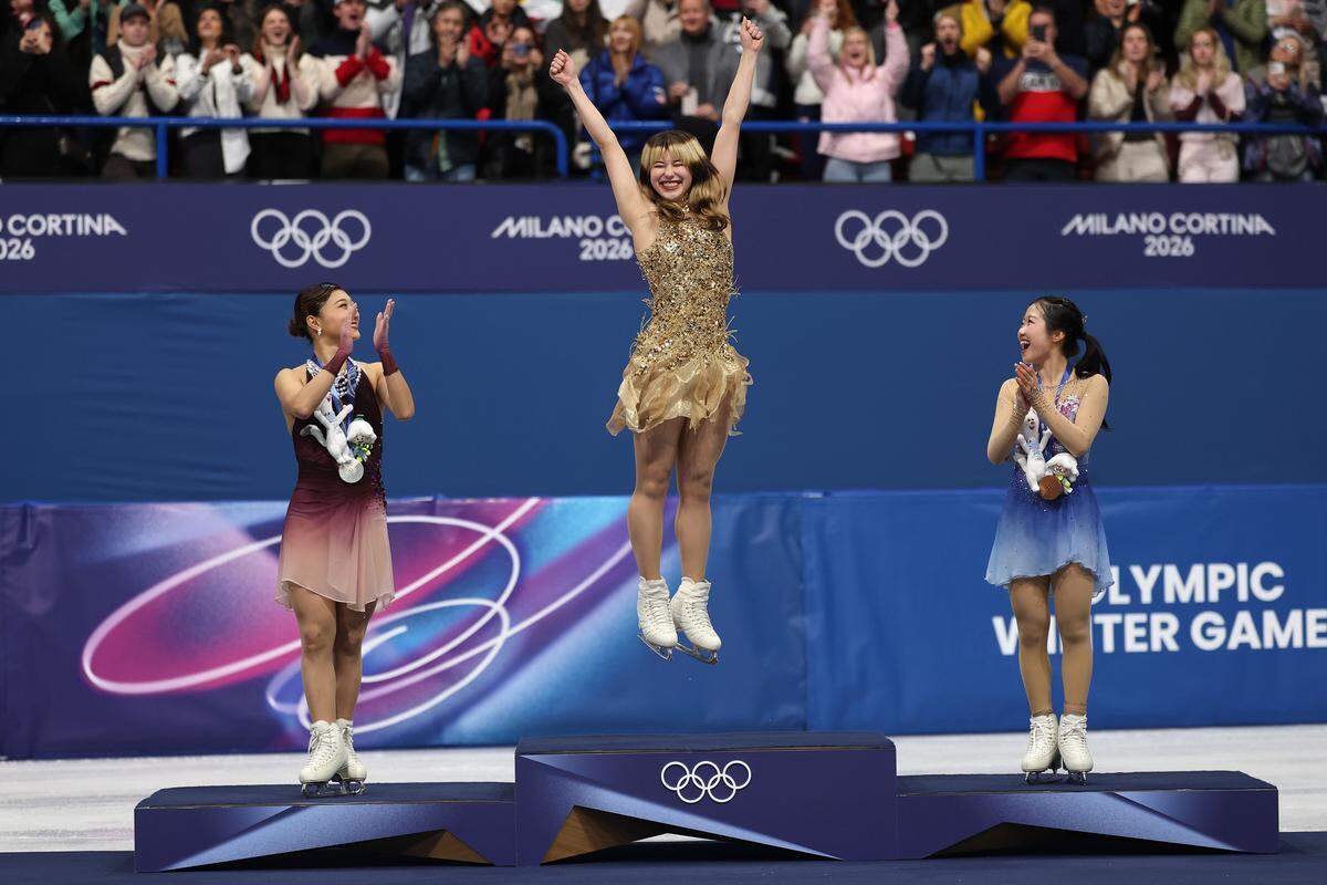 MILAN, ITALY - FEBRUARY 19: Gold medalist Alysa Liu of Team United States celebrates on the podium during the medal ceremony for the Women's Single Skating on day thirteen of the Milano Cortina 2026 Winter Olympic games at Milano Ice Skating Arena on February 19, 2026 in Milan, Italy. (Photo by Matthew Stockman/Getty Images)