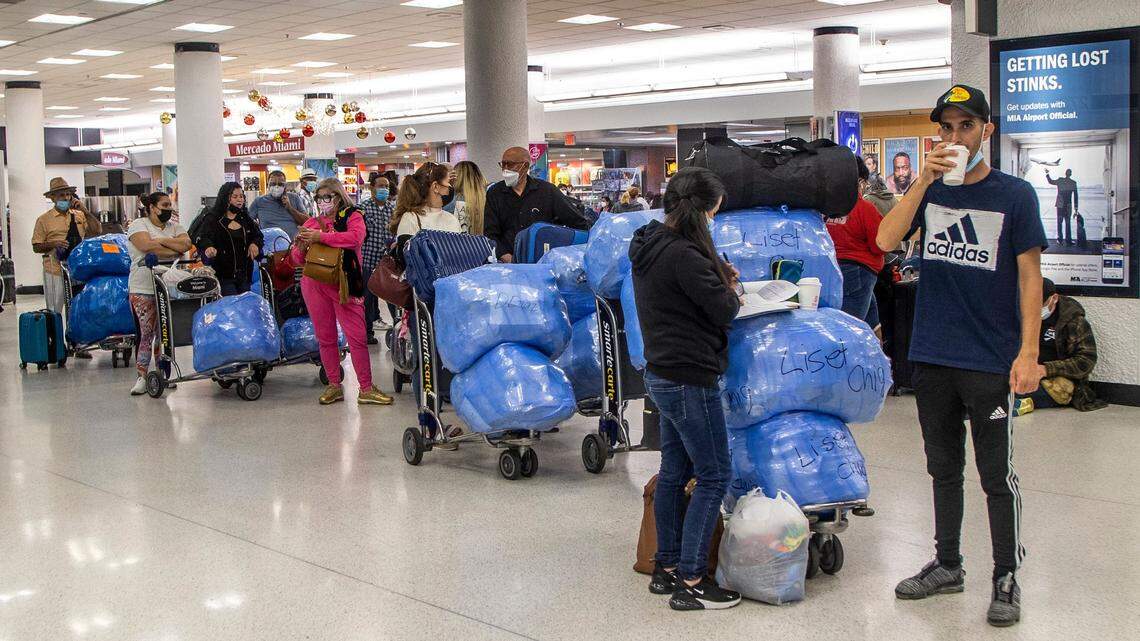 Passengers at Miami International Airport headed for Cuba board planes loaded down with packages. Many contain  prescription and over the counter medicine.