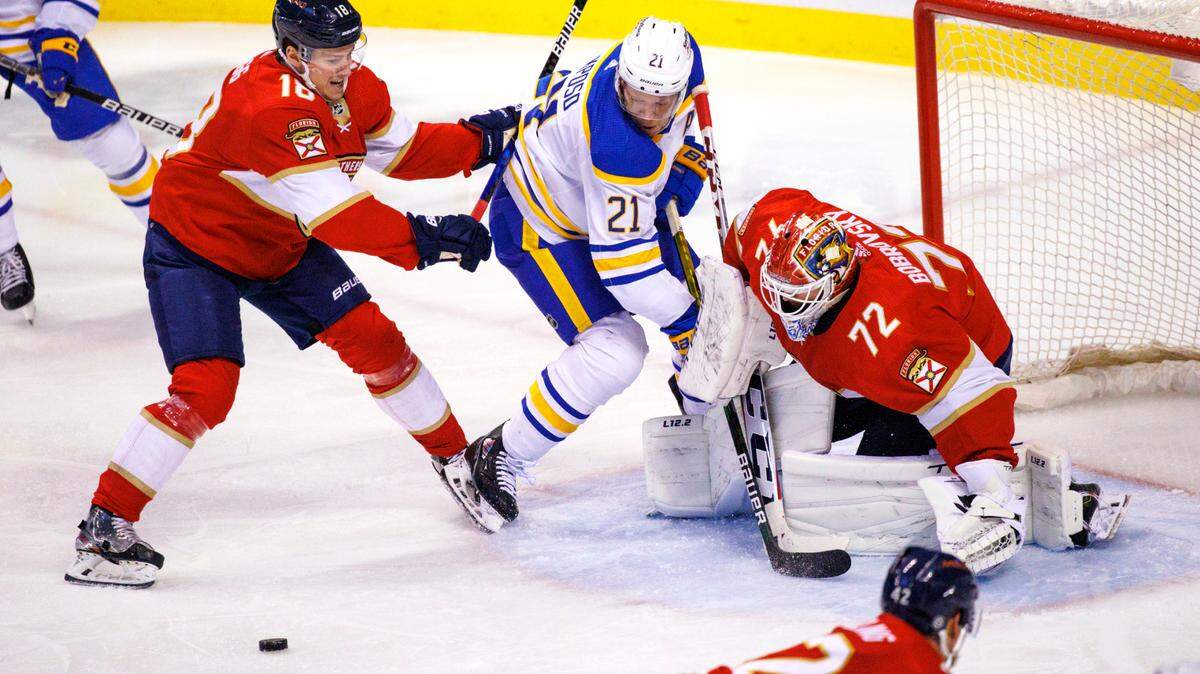 Florida Panthers defenseman Robert Hagg (18) and Panthers goaltender Sergei Bobrovsky (72) defend the goal from Buffalo Sabres right wing Kyle Okposo (21) during the third period of an NHL game at the FLA Live Arena on Friday, April 8, 2022 in Sunrise, Fl.