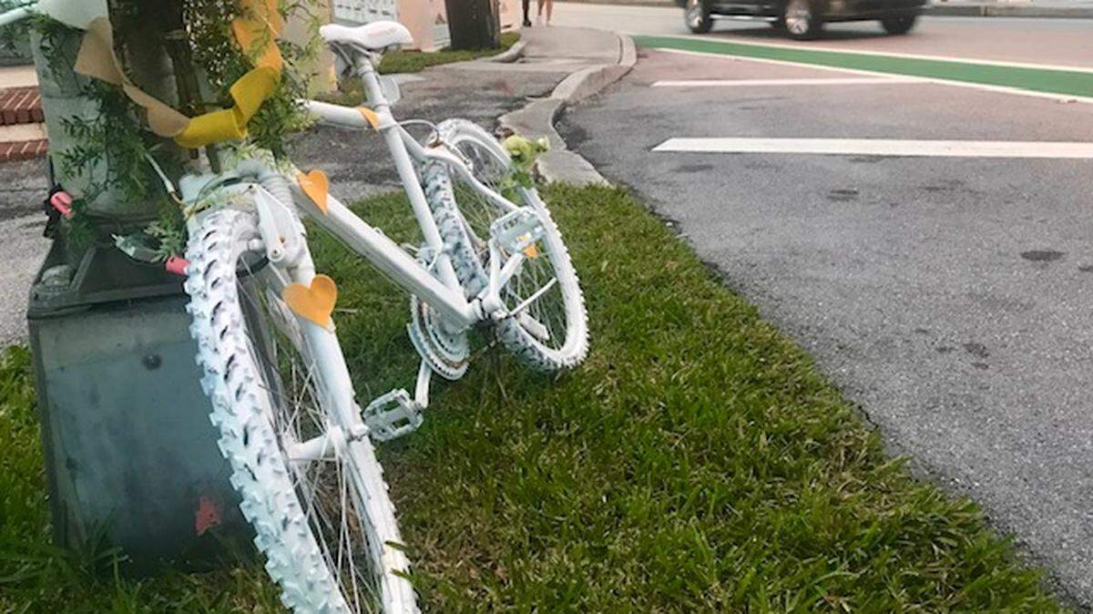 A “ghost bike” memorial in honor of Flavia Carnicelli has been placed beside the Venetian Causeway, near the spot where she was killed by a motorist last year.