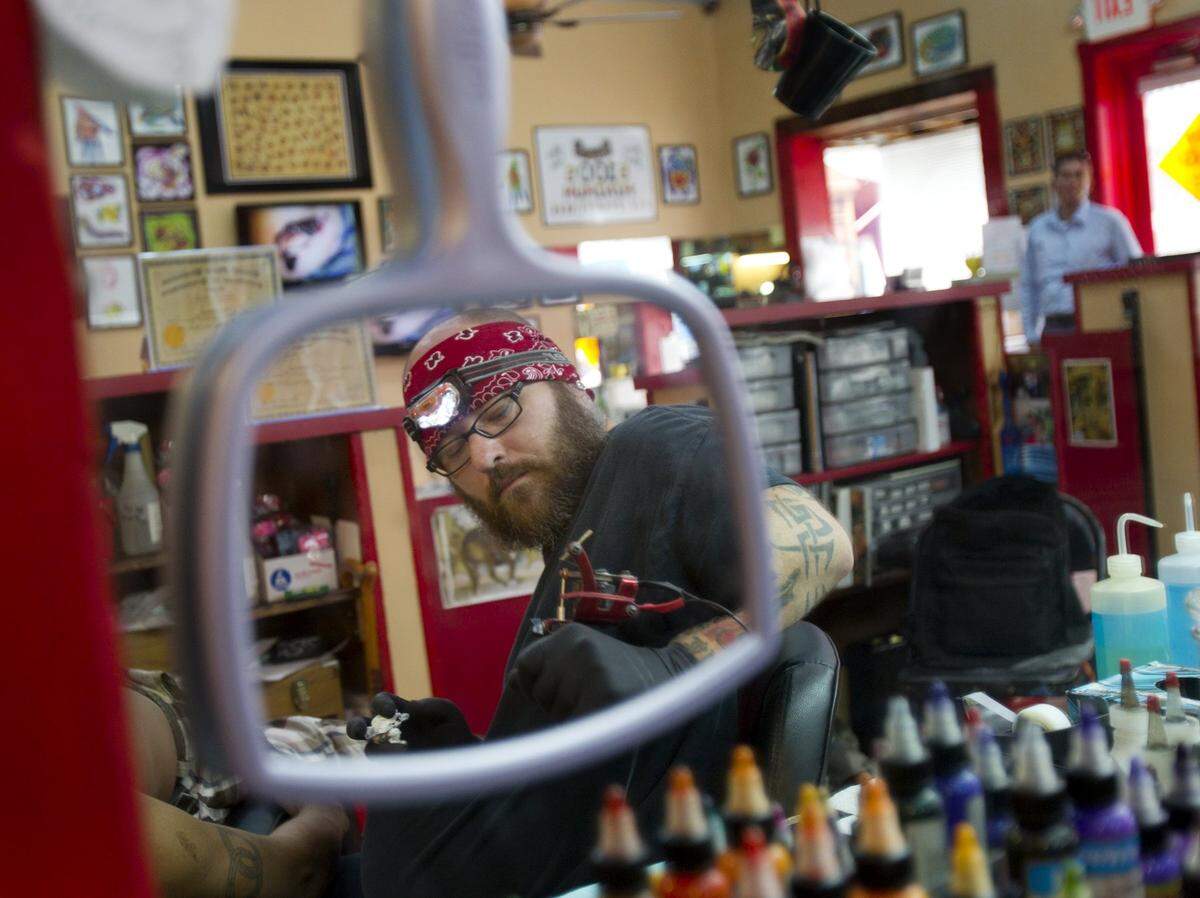 Tattoo Artist J.D. Hoadley applies his trade at Southermost Tattoo parlor on Duval Street in Key West.