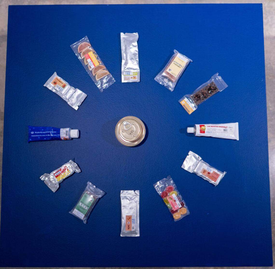 Untitled (Russian Rations), 2024, acquired objects. n assemblage on a plinth featuring Russian space food used on the International Space Station.