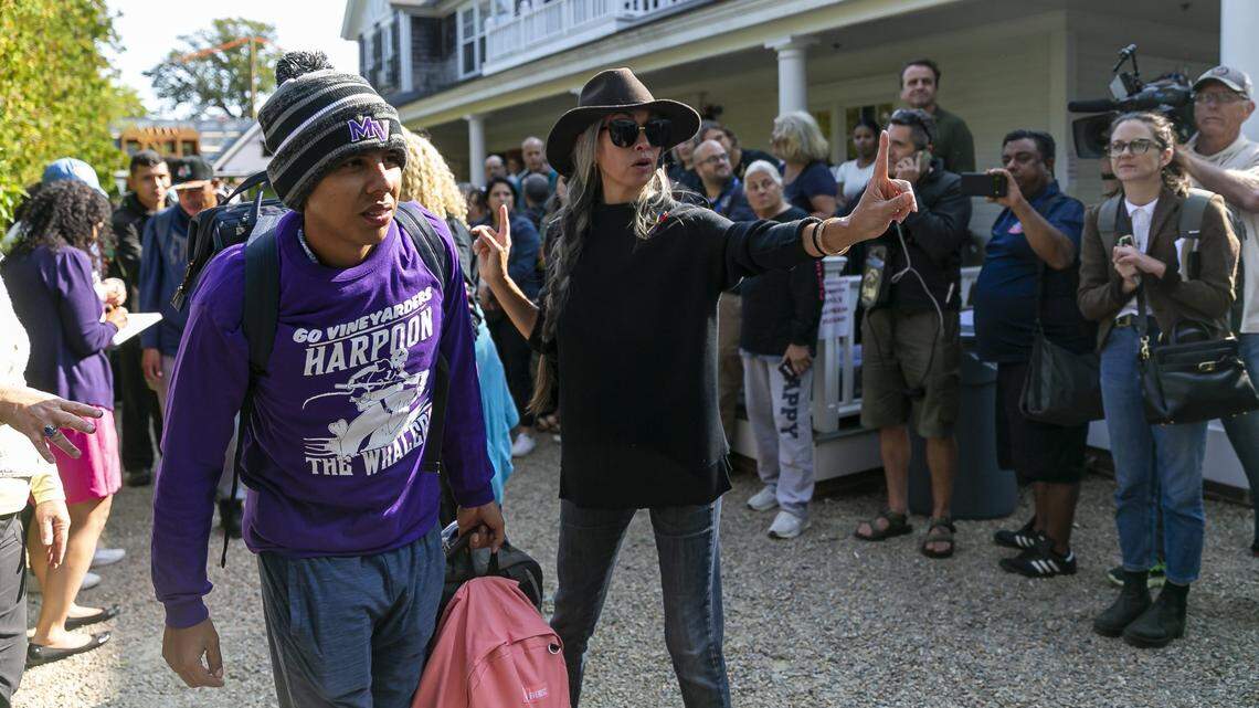 A Venezuelan migrant is led onto a bus at St. Andrews Episcopal Church on Friday, Sept. 16, 2022, in Edgartown, Massachusetts, on the island of Martha’s Vineyard. A group of 48 migrants was flown to the island from Texas earlier in the week, leaving them stranded. They are now being transferred to a military base in Cape Cod.