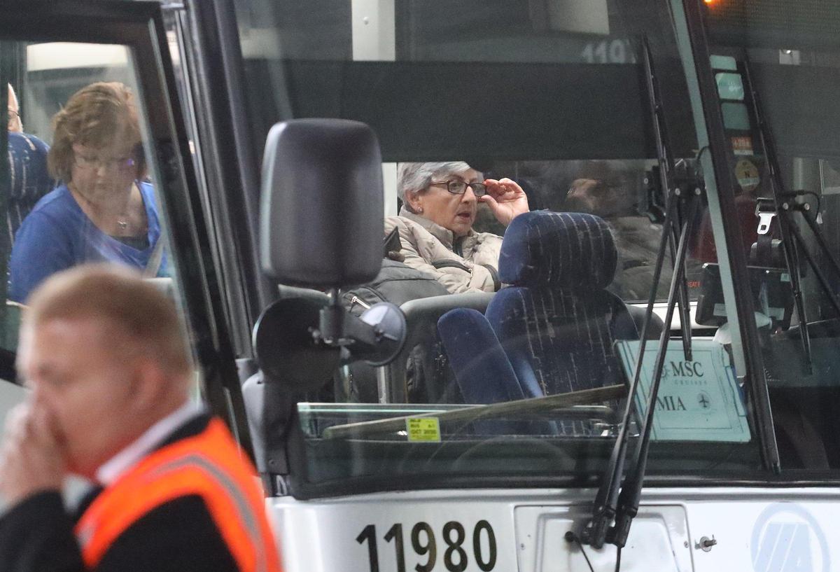 Cruisers board buses after disembarking at Terminal F at PortMiami on Monday, March 9, 2020, after a weekend of cruise-related coronavirus transmission and a State Department warning.