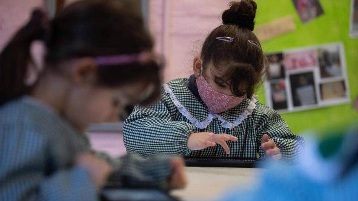 Preschool children use tablets during a class at a public school in Montevideo, Uruguay, amid the coronavirus COVID-19 pandemic.