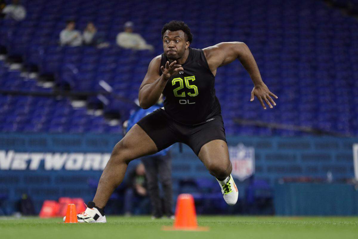 In this Feb. 28, 2020, file photo, USC offensive lineman Austin Jackson runs a drill at the NFL football scouting combine in Indianapolis. The Dolphins selected Jackson 18th in Thursday’s NFL Draft.