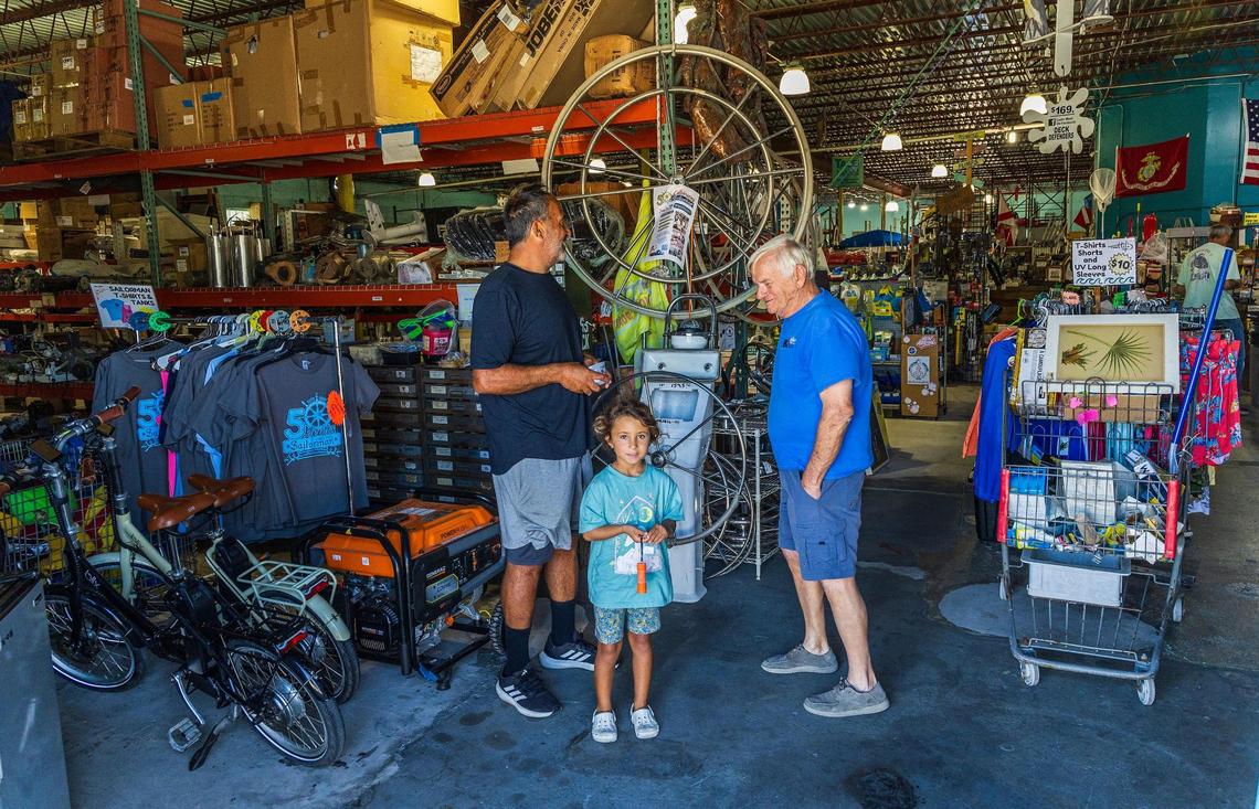 Owner Chuck Fitzgerald (far right) welcomes Nick Homayed and his daughter Gena who are visiting from Philadelphia to the Sailorman warehouse dubbed as “The World’s Largest and Most Unique New and Used Marine Emporium” celebrating the 50th Anniversary this month, in Fort Lauderdale, on Tuesday March 11, 2024.
