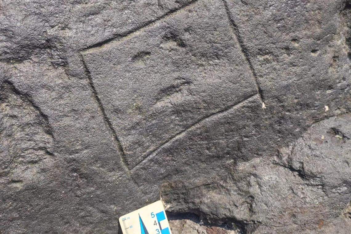 A rectangular face carving.