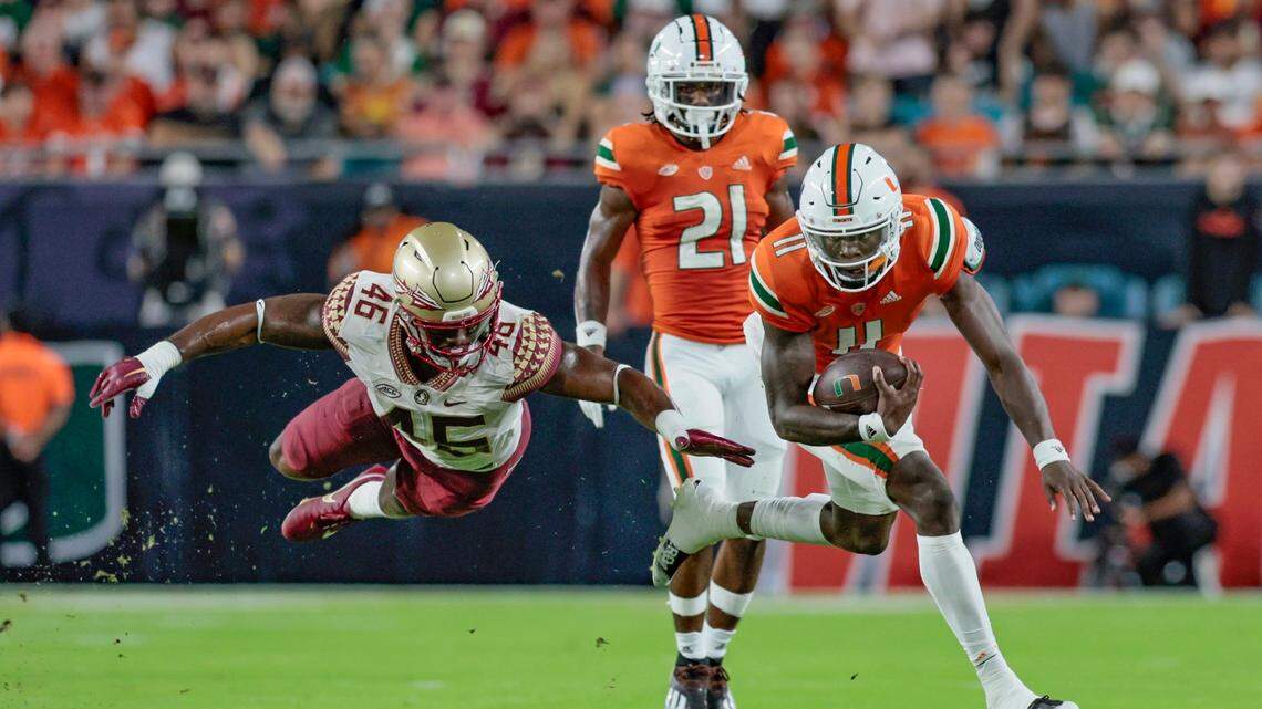 Florida State Seminoles linebacker DJ Lundy (46) is airborne as he attempts to stop Miami Hurricanes quarterback Jacurri Brown (11) in the first half at Hard Rock Stadium in Miami Gardens on Saturday, November 5, 2022.