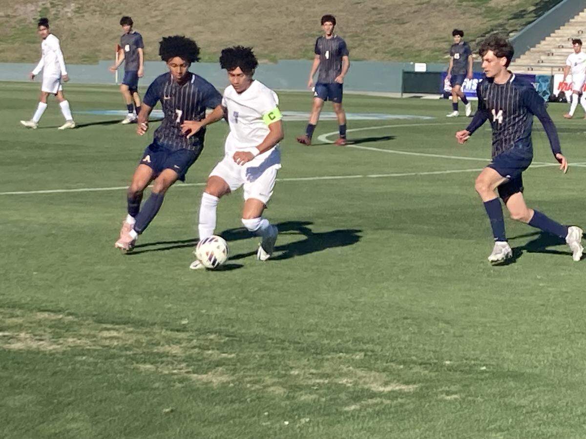 St. Thomas Aquinas midfielder Tyler Hinkle (left) battles Sunlake forward Jairo Todd for a loose ball during a Class 6A boys’ soccer state semifinal at SpecMartin Stadium in DeLand, Fla.