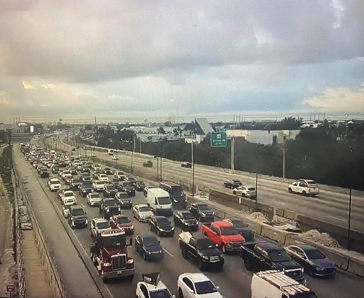 Cars are stopped along I-95 in Broward County Friday morning, Nov. 24, 2023, after a tractor crash involving several vehicles.