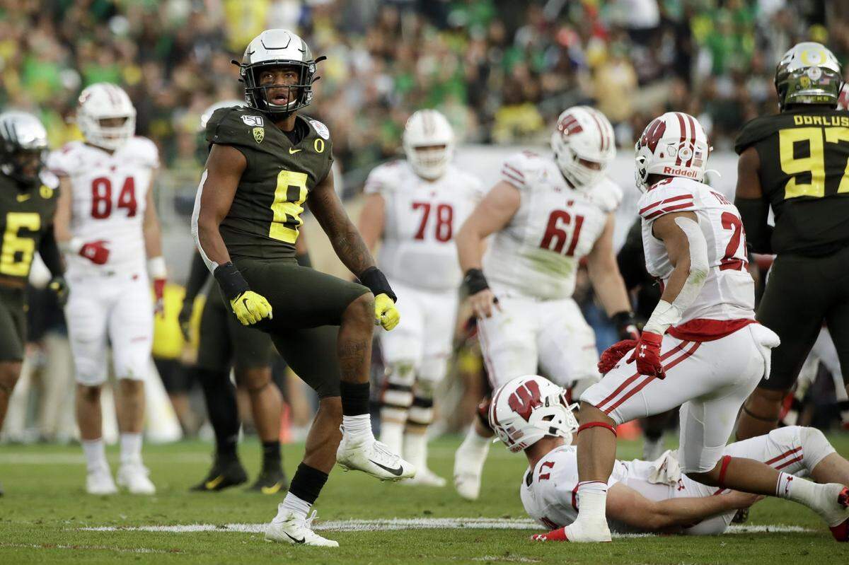 Oregon safety Jevon Holland celebrates after sacking Wisconsin quarterback Jack Coan during second half of the Rose Bowl NCAA college football game Wednesday, Jan. 1, 2020, in Pasadena, Calif. (AP Photo/Marcio Jose Sanchez)