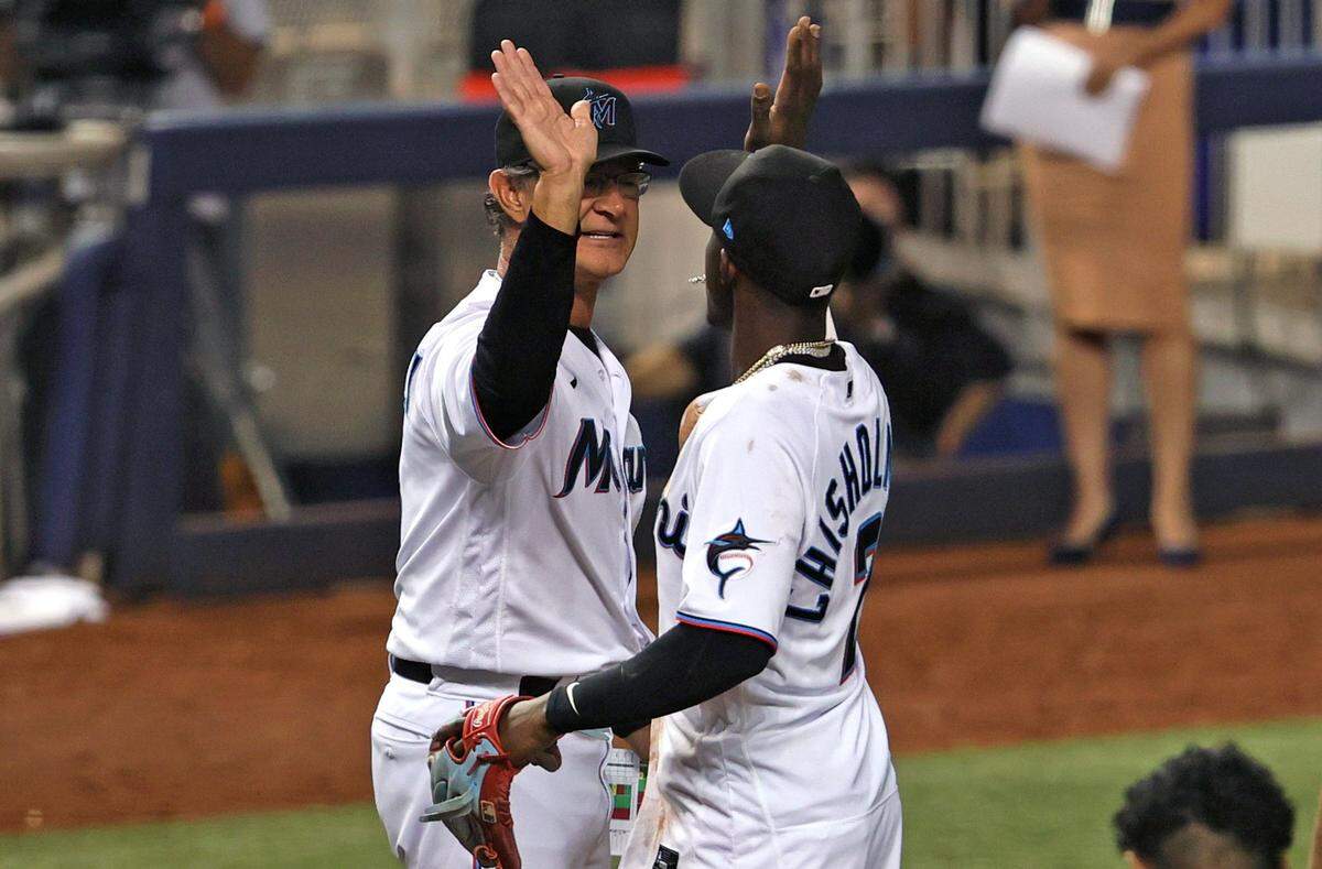 Miami Marlins second baseman Jazz Chisholm Jr. (2) and manager Don Mattingly (8) celebrate their 3-2 win over the New York Mets during the baseball game at loanDepot park on Thursday, September 9, 2021 in Miami, Florida.