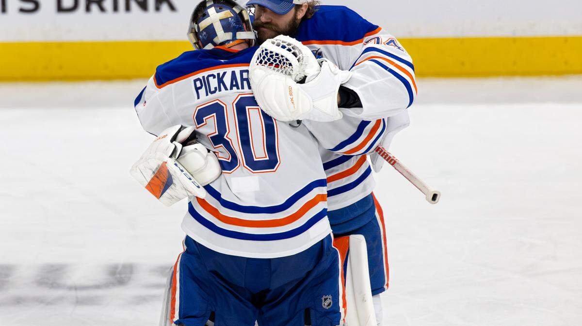 Edmonton Oilers goaltenders Calvin Pickard (30) and Stuart Skinner (74) celebrate after a 5-4 overtime win against the Florida Panthers in Game 4 of the NHL Stanley Cup Final at Amerant Bank Arena on Thursday, June 12, 2025, in Sunrise, Fla.