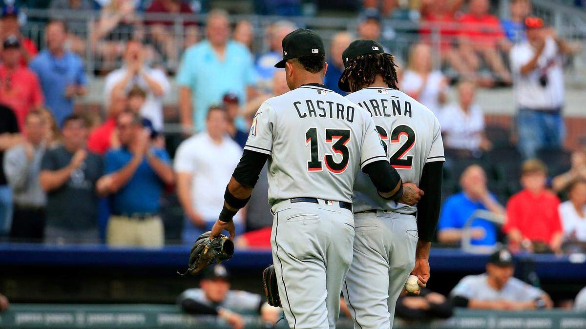 Miami Marlin’s Jose Urena is escorted off of the field by Starlin Castro #13 after being ejected during the first inning against the Atlanta Braves at SunTrust Park on August 15, 2018 in Atlanta, Georgia.