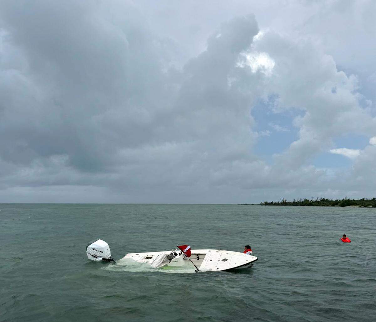 A boat sinks in the ocean off the Florida Keys Wednesday morning, July 24, 2024. The people were rescued by the Monroe County Sheriff’s Office.