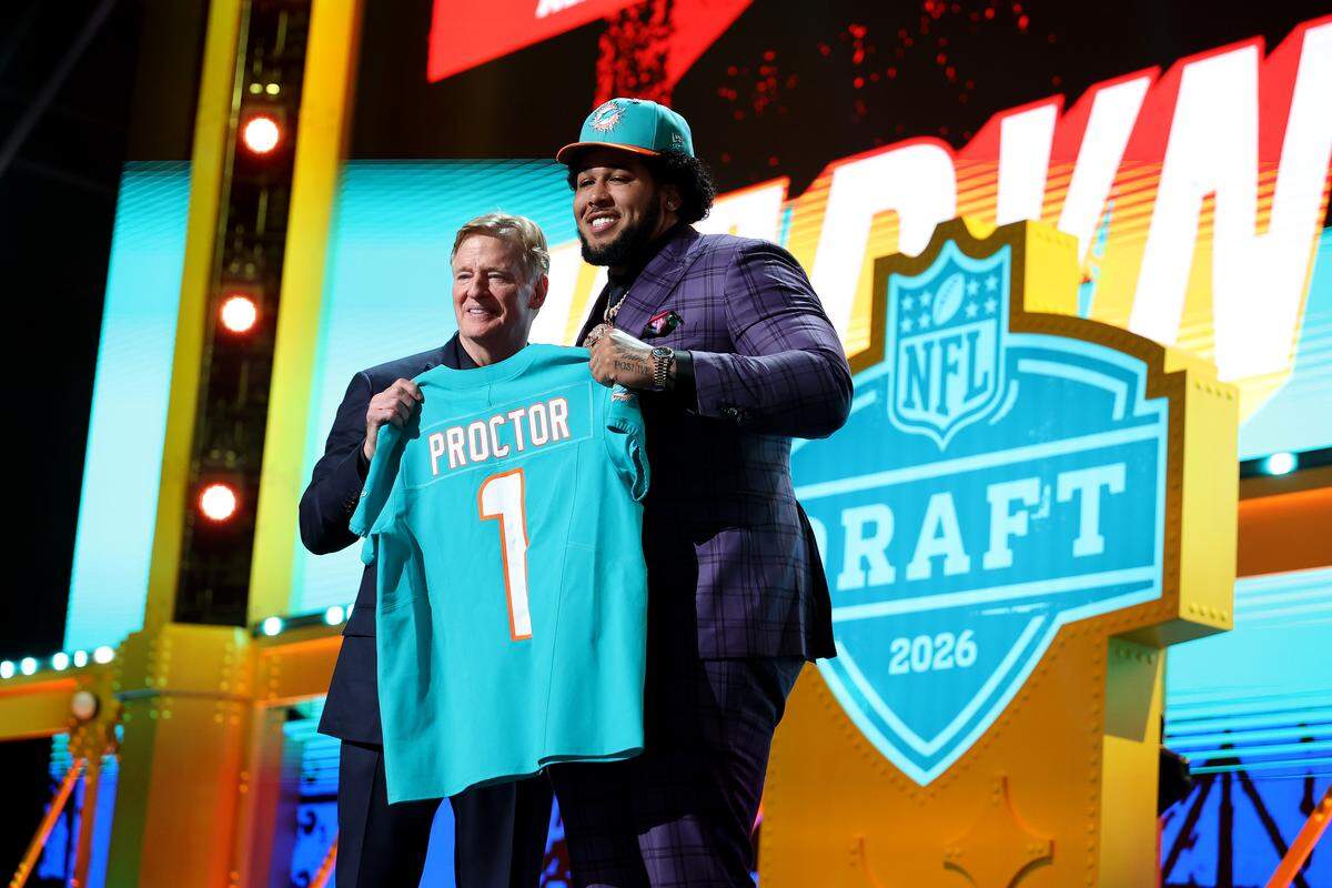 PITTSBURGH, PENNSYLVANIA - APRIL 23: Kadyn Proctor (R) of Alabama poses with NFL Commissioner Roger Goodell (L) after being selected twelfth overall pick by the Miami Dolphins during Round One of the 2026 NFL Draft at Acrisure Stadium on April 23, 2026 in Pittsburgh, Pennsylvania. (Photo by Emilee Chinn/Getty Images)
