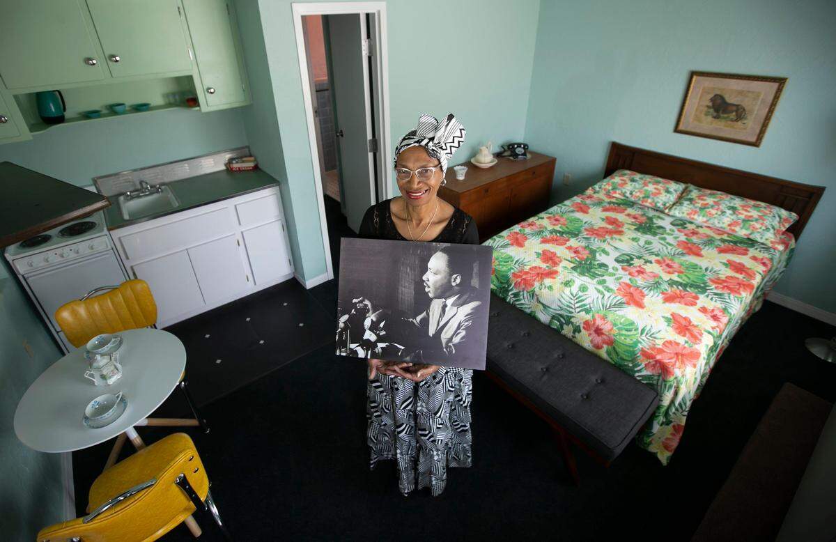 The president/CEO of the Historic Hampton House, Charlayne W. Thompkins, holds a photograph of Martin Luther King Jr. while standing inside one of his favorite rooms at the Hampton House in Miami. It is said that King gave one of the early versions of his pivotal ‘I Have a Dream’ speech at the Hampton House.