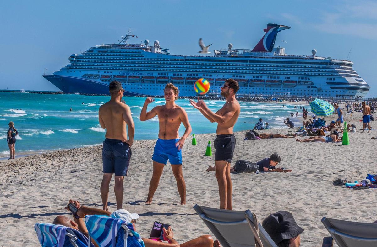 The Carnival Conquest cruise ship departs from PortMiami through the Government Cut channel as beachgoers enjoy the nice weather in South Beach, during the spring break, in Miami Beach, Florida. on Friday March 21, 2025.