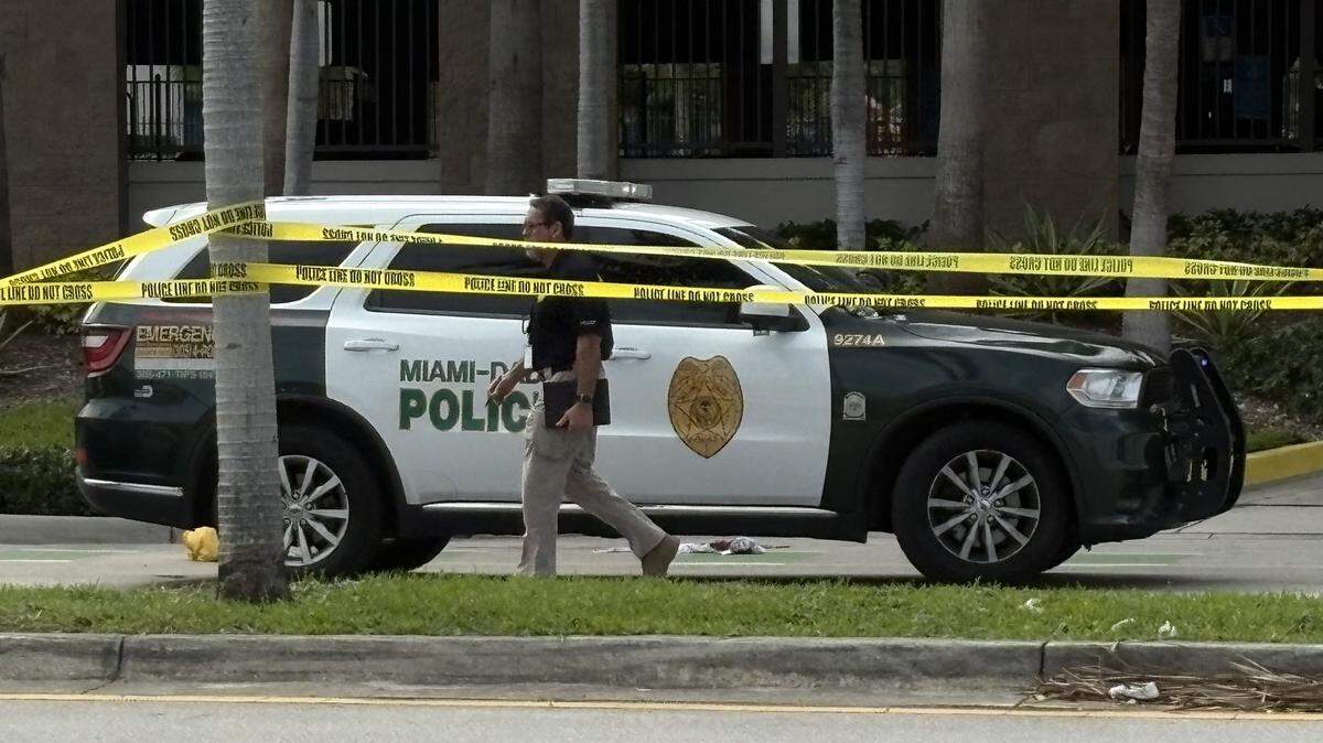 A detective walks past a crime scene at a Walmart in Goulds Thursday, Nov. 9, 2025. The Miami-Dade Sheriff’s Office said a deputy wounded an armed man during a struggle at the store.