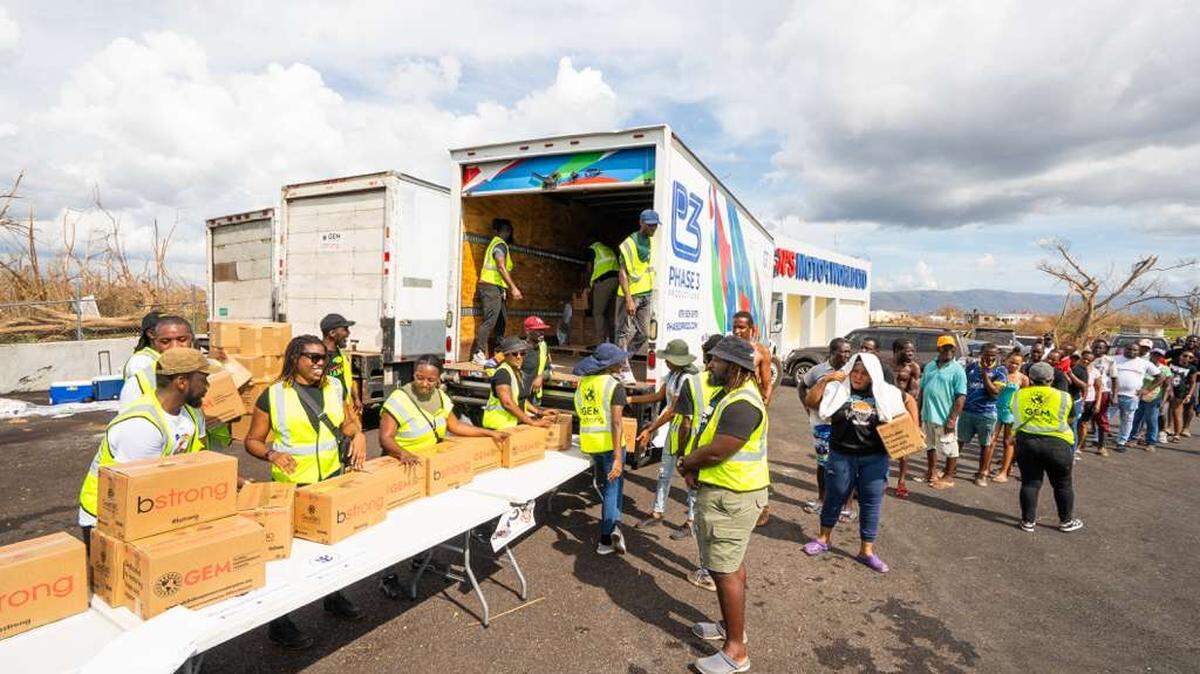 Global Empowerment Mission volunteers distribute boxes of aid to people in Jamaica after Hurricane Melissa devastated the island.