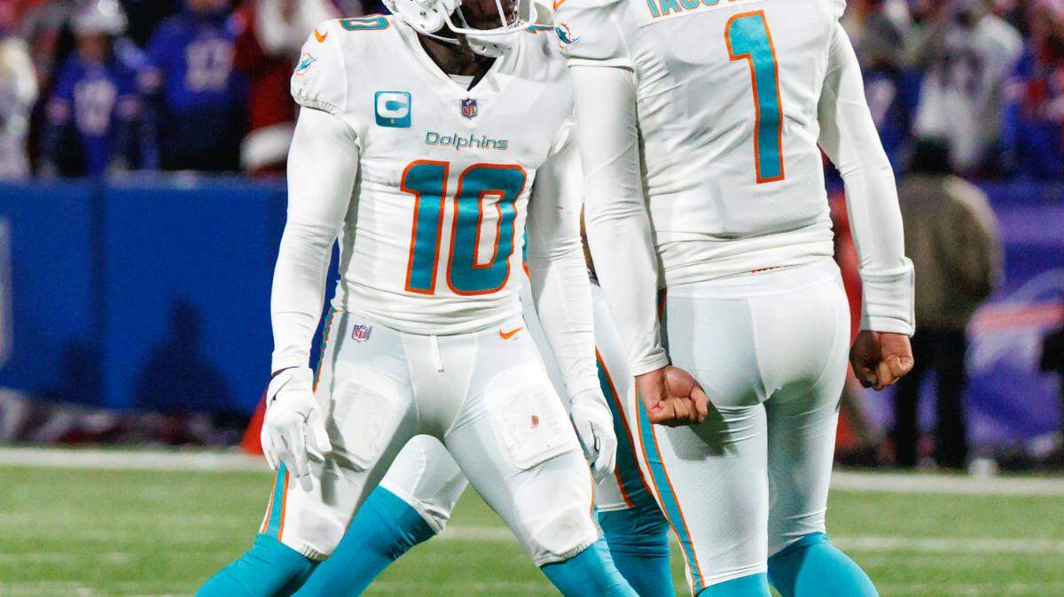 Miami Dolphins wide receiver Tyreek Hill (10) celebrates with teammate Tua Tagovailoa (1) after scoring a touchdown during third quarter of an NFL football game against the Buffalo Bills at Highmark Stadium on Saturday, December 17, 2022 in Orchard Park, New York.