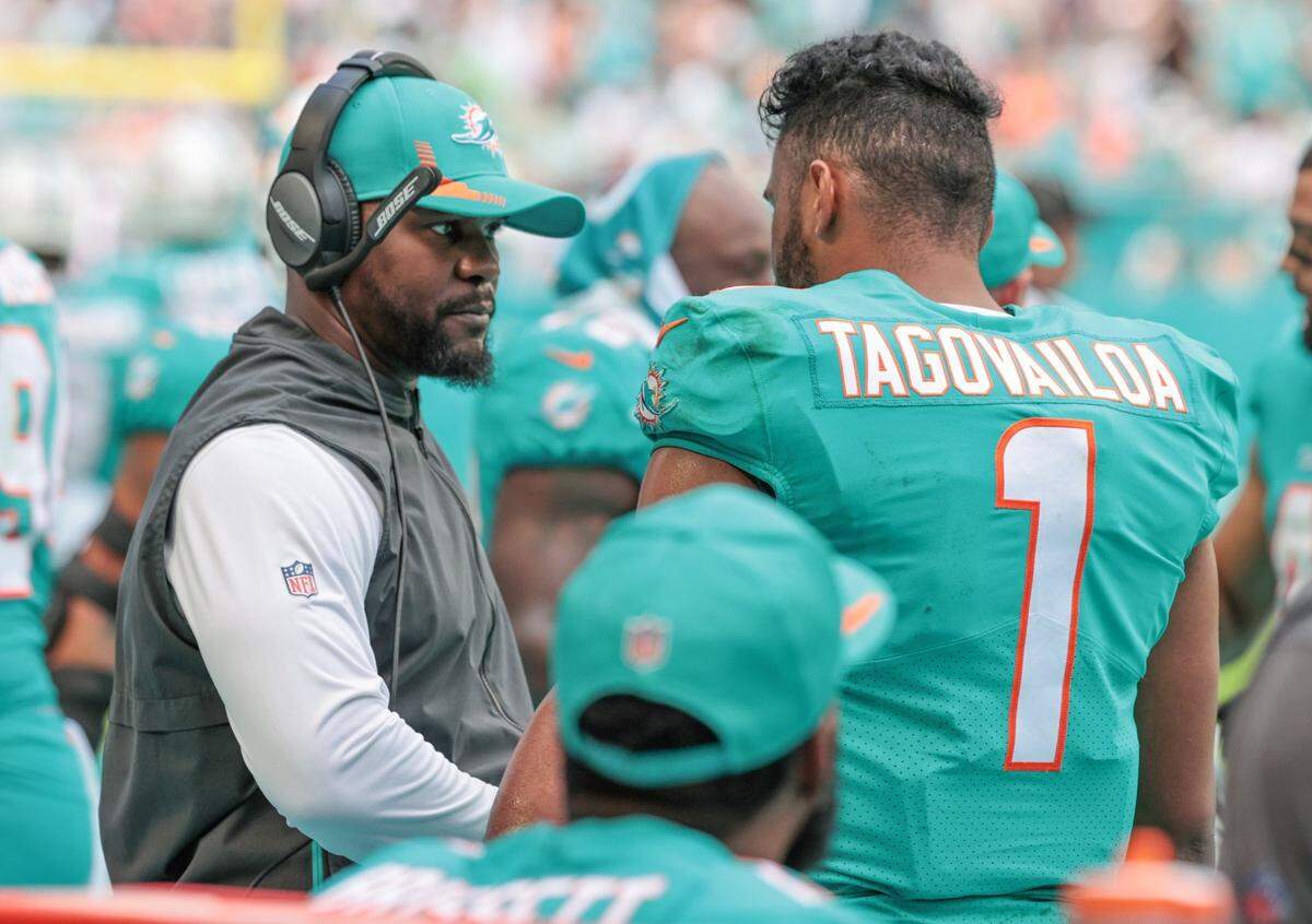 Miami Dolphins head coach Brian Flores talks with Miami Dolphins quarterback Tua Tagovailoa during the game against the New York Jets at Hard Rock Stadium in Miami Gardens on Sunday, Dec. 19, 2021.