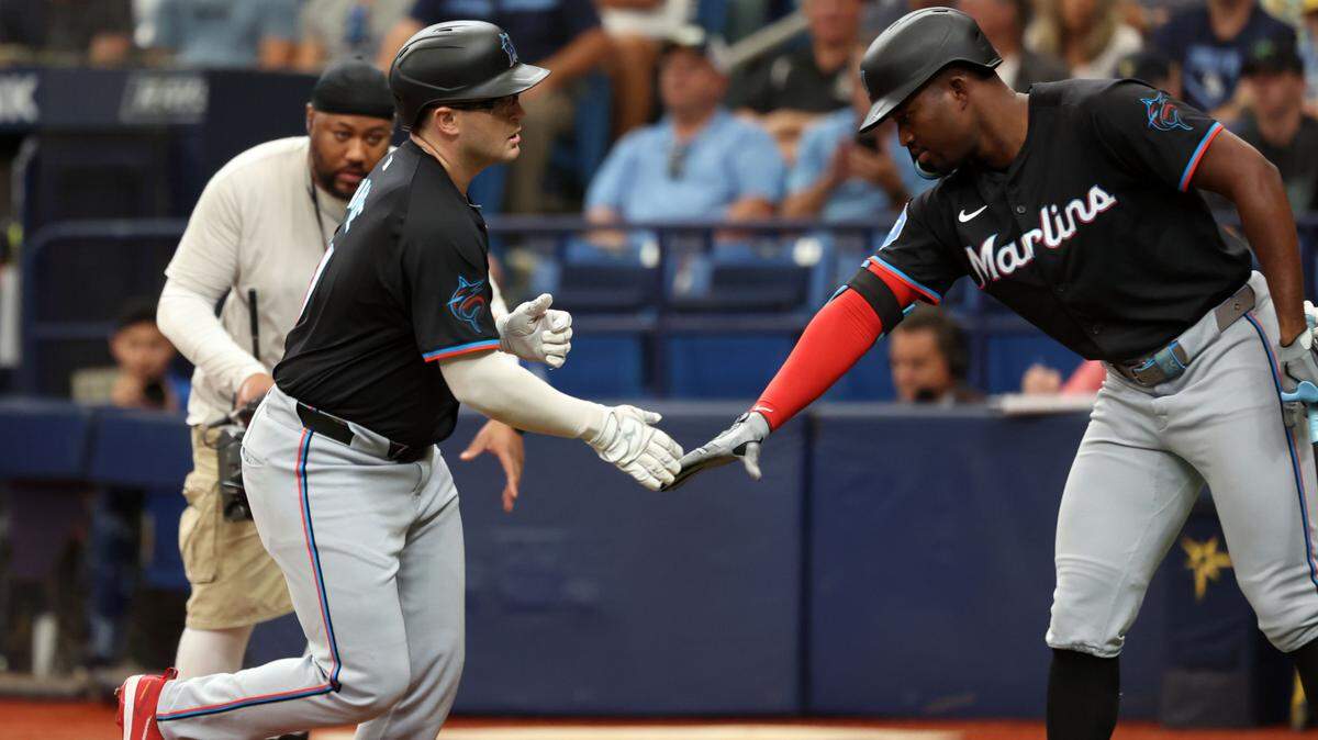 Jul 31, 2024; St. Petersburg, Florida, USA; Miami Marlins third base Jonah Bride (41) celebrates with outfielder Jesus Sanchez (12) after hitting a home run against the Tampa Bay Rays during the second inning at Tropicana Field. Mandatory Credit: Kim Klement Neitzel-USA TODAY Sports