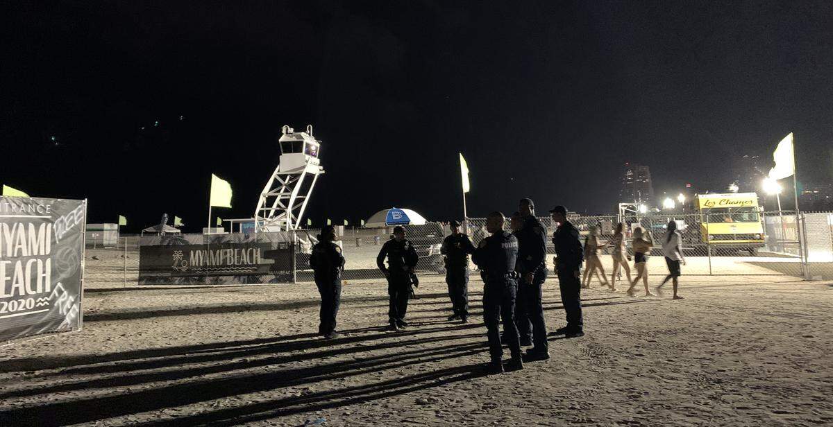 Miami Beach Police officers stand outside the city-sponsored spring break event space in South Beach near 10th Street and Ocean Drive on Friday, March 6, 2020. Police slammed a spring breaker to the ground and arrested her after an incident with security guards Friday evening. The rough arrest was captured on video.