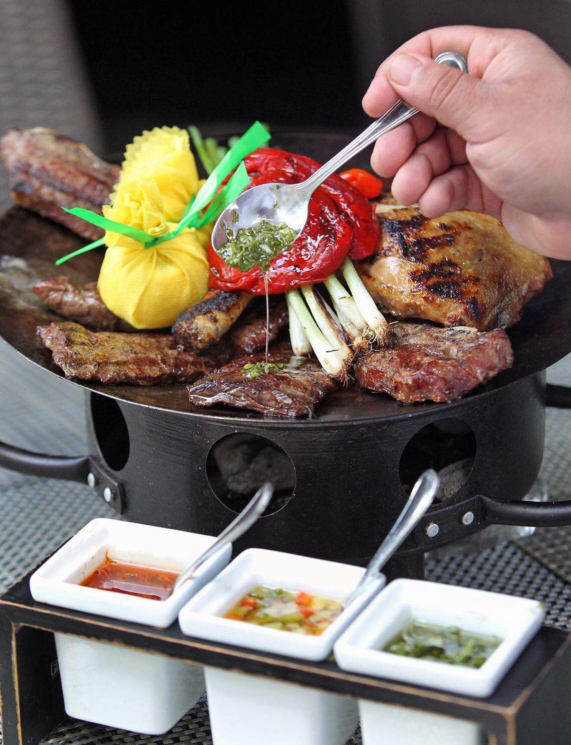 Baires Grill parrilladas include steak, ribs, chorizo, blood sausage, chicken and Chimichurri sauce.