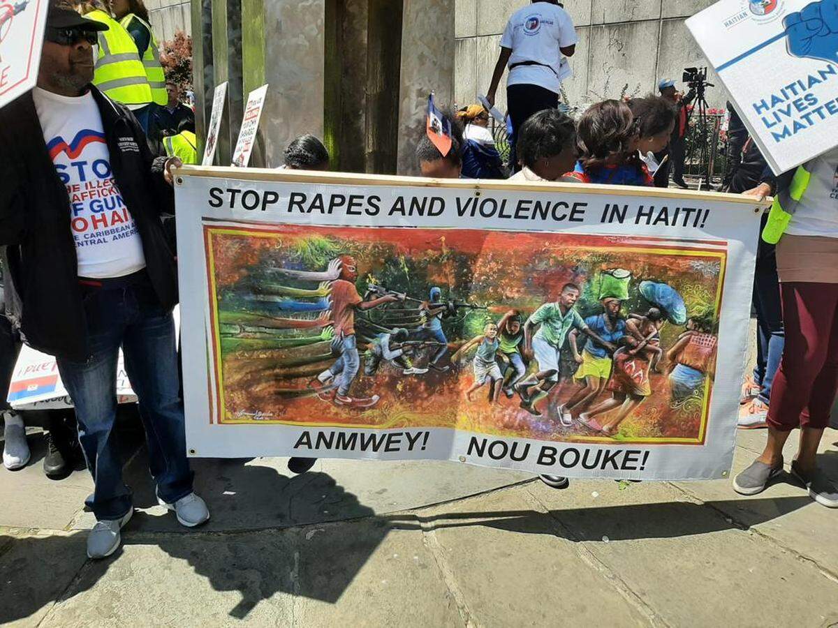 Haitians in New York marked Haitian Flag Day, May 18, 2023, by marching across the Brooklyn Bridge to protest the illegal trafficking of arms into Haiti from the United States. This banner in Creole reads, “Oh, my God. We are fed up!”