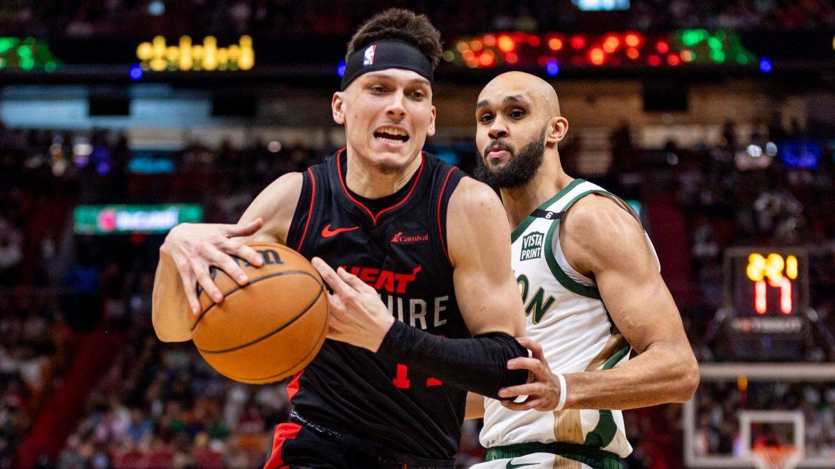 Miami Heat guard Tyler Herro (14) drives past Boston Celtics guard Derrick White (9) during the first half of an NBA game at Kaseya Center in Miami, Florida, on February 11, 2024.