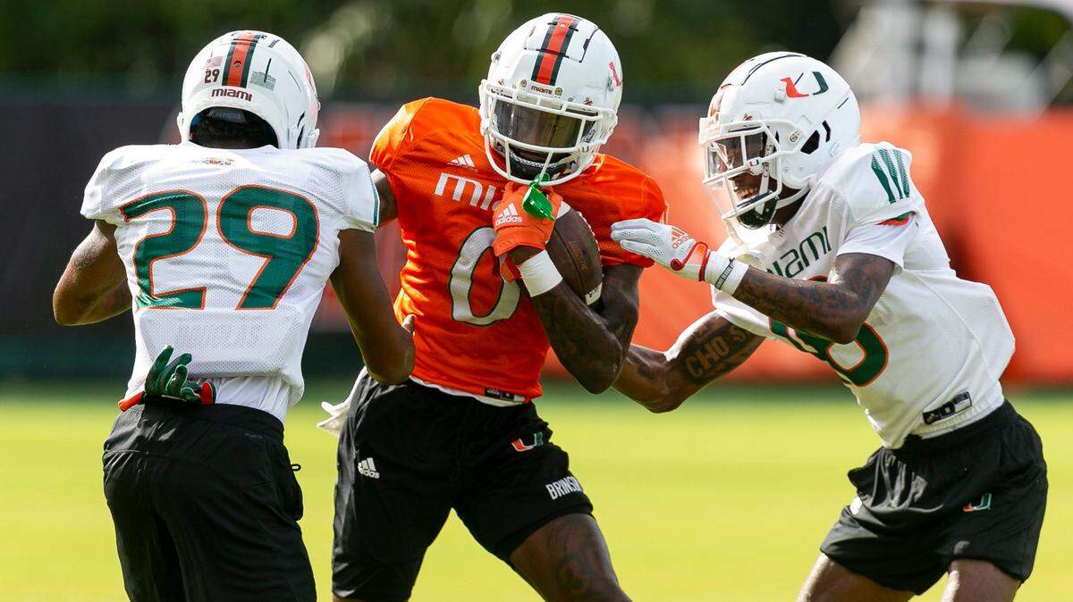 From left to right: Miami Hurricanes cornerback Isaiah Dunson (29), wide receiver Romello Brinson (0) and defensive back Markeith Williams (18) run drills at the University of Miamis Greentree Practice Fields on Monday, Aug. 8, 2022, in Coral Gables, Fla.