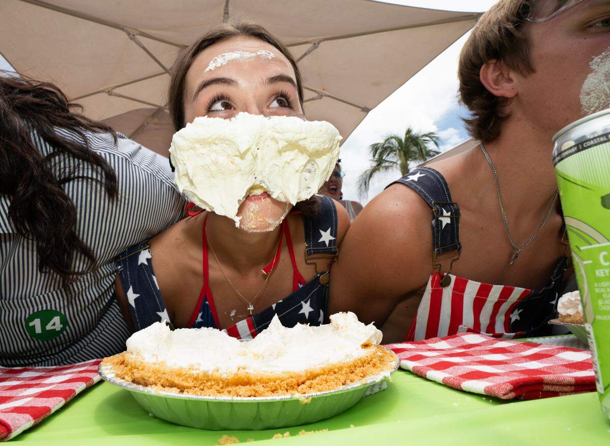 Maddie Miller, of Tampa, raises her head during the World Famous Key Lime Pie Eating Championship Tuesday, July 4, 2023, in Key West.