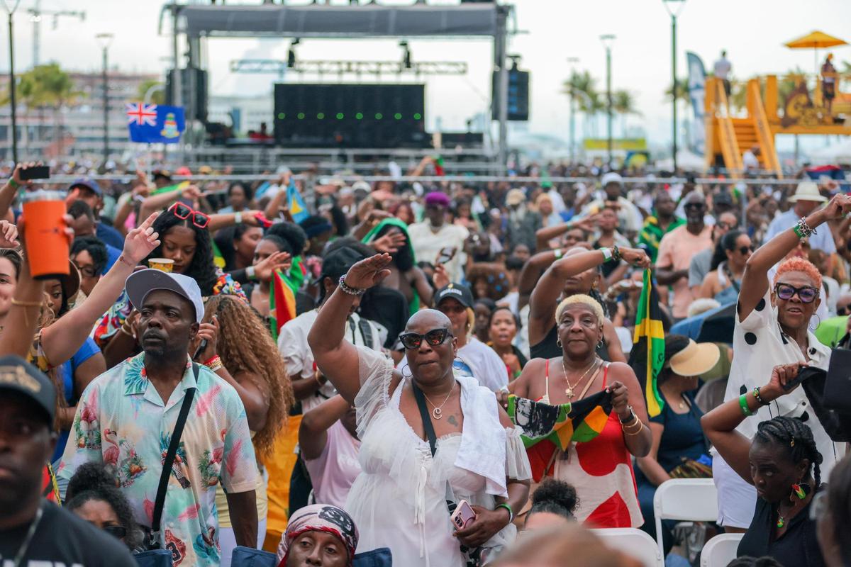 Concertgoers wave their arms to the rhythm of the music during the 19th annual Best of the Best International Music Festival at Bayfront Park in downtown Miami, Sunday, May 25, 2025.