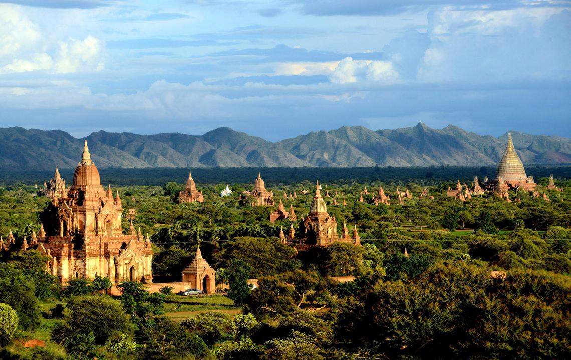 In this Aug. 15, 2013 photo, ancient temples stand in Bagan, central Myanmar. After closing its doors to the West for half a century, Myanmar has reopened, inviting all to come and discover its treasures, ancient palaces of kings long gone, legends and mysteries told in stone. With ill-equipped roads and railways, there is no better way to explore than by river. Public ferries crisscross through glistening green paddies; old teak fishing boats can be rented by the day. (AP Photo/Khin Maung Win)