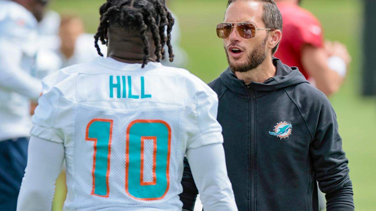 Miami Dolphins head coach Mike McDaniel speaks with Miami Dolphins wide receiver Tyreek Hill (10) during practice drills at Baptist Health Training Complex in Miami Gardens on Wednesday, October 12, 2022.