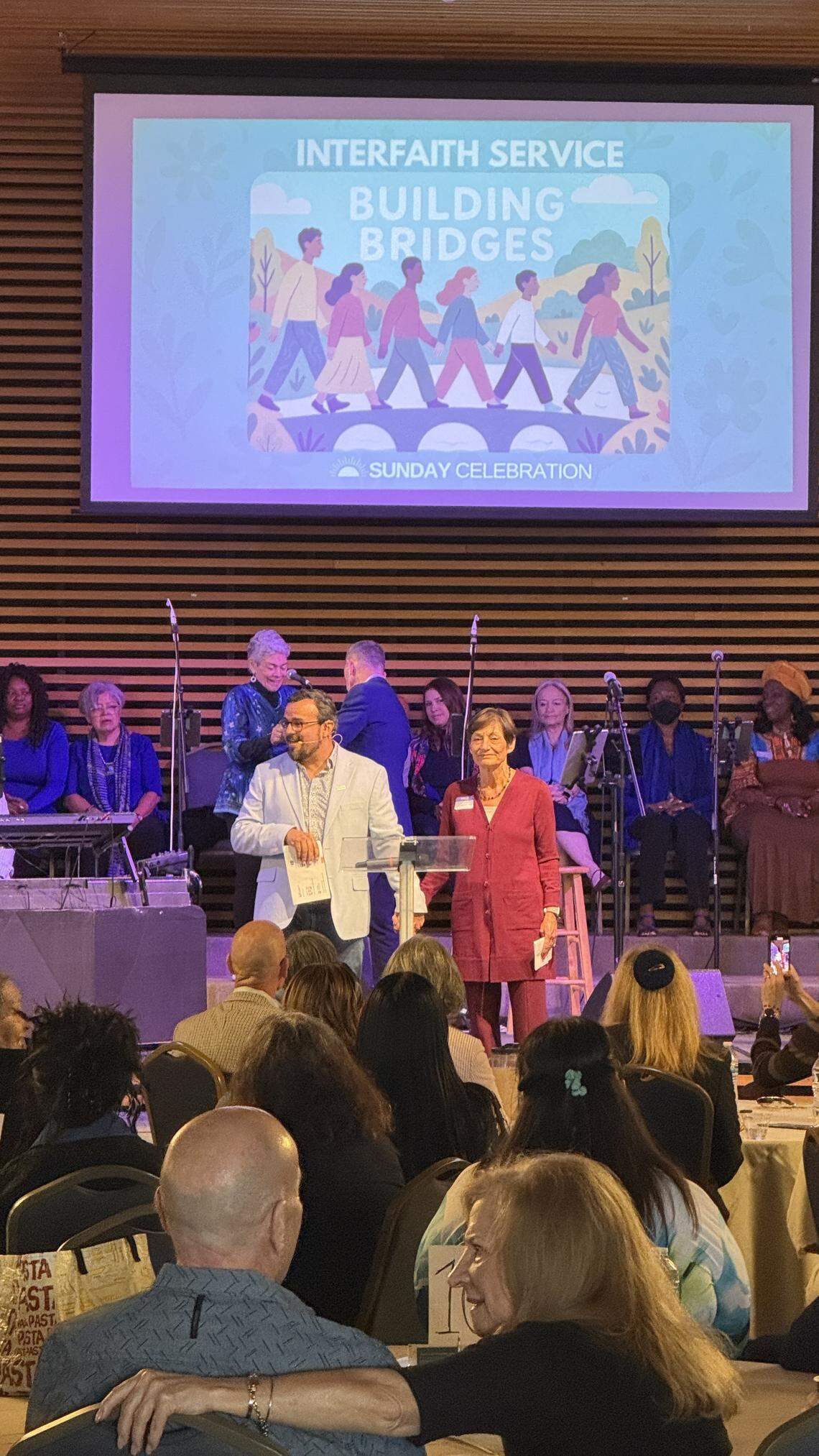Rev. Juan del Hierro, senior minister at Unity on the Bay and Joanne Koren, co-chair of Temple Beth Am’s Unbiased Initiative, speak at an interfaith potluck at Unity on the Bay located at Temple Israel.