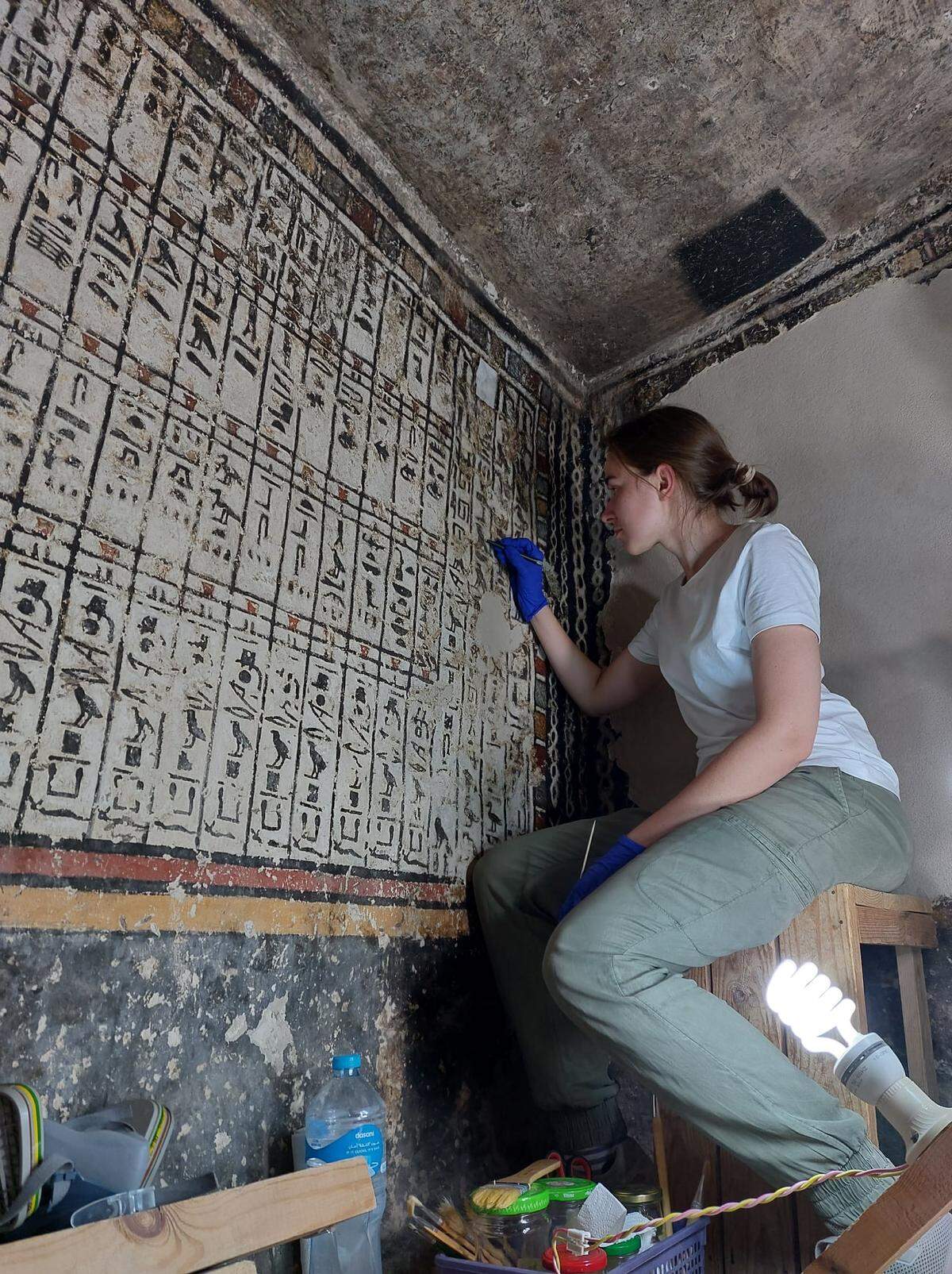 An archaeologists working on the paintings.