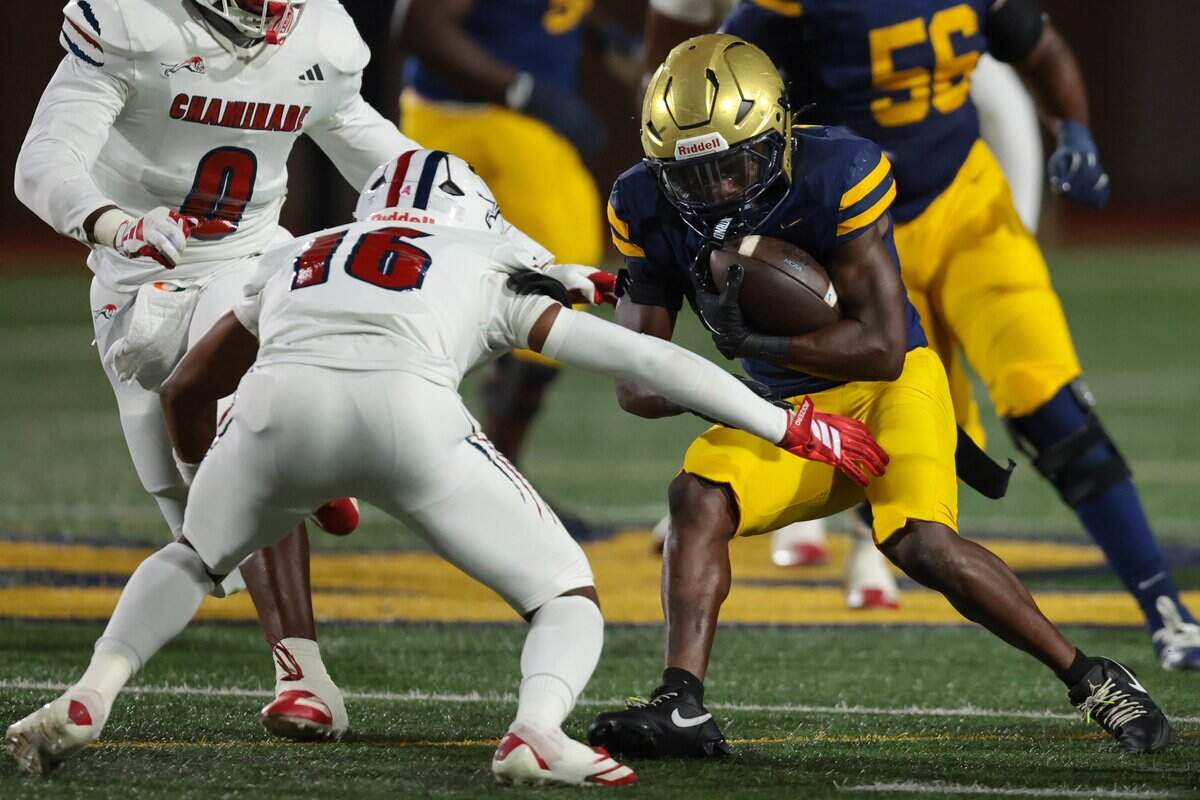 St. Thomas Aquinas Raiders running back Virgil Lemons (0) carries the football against Chaminade-Madonna Lions defensive back Angelo Smith (16) during the first quarter of a high school football game at St. Thomas Aquinas in Fort Lauderdale, Florida, Friday, October 31, 2025.