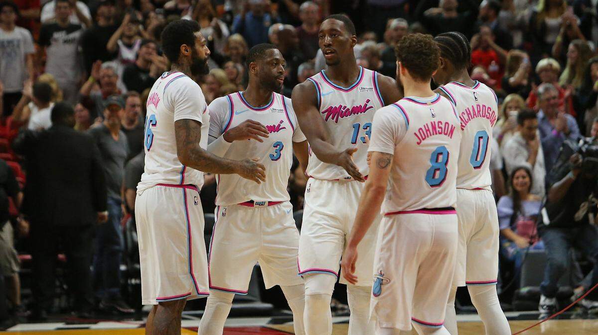 Miami Heat player James Johnson #16,  Bam Adebayo #13 Tyler Johnson #8 and Josh Richardson #0 congratulate  Dwyane Wade after they defeated the Milwaukee Bucks  91-85 in a NBA basketball game at the AmericanAirlines Arena in Miami on Friday, February 9, 2018.
