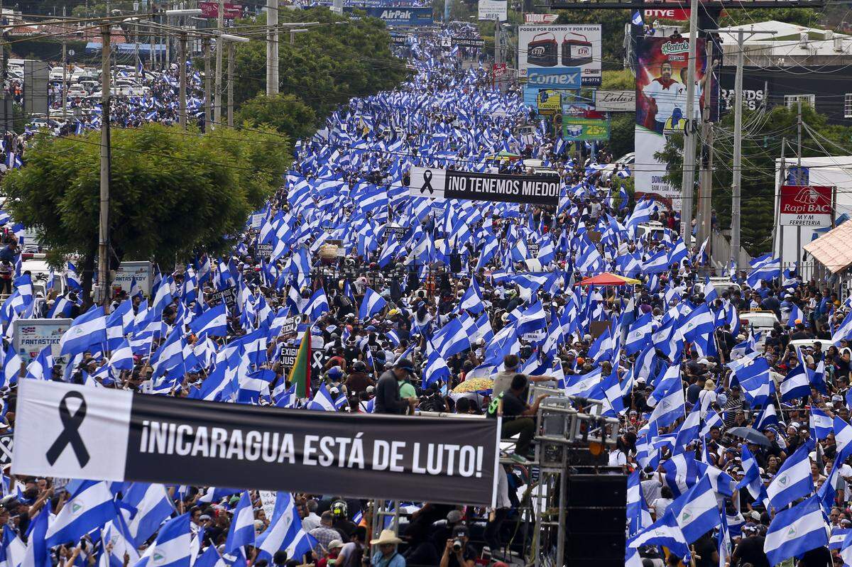 Tens of thousands march against Nicaragua's President Daniel Ortega in Managua, Nicaragua, Wednesday, May 30, 2018. Violence returned to protests against Nicaraguan President Daniel Ortega's government when riot police and government supporters confronted protesters during a Mother's Day march to commemorate those mothers who have  lost their children during the ongoing protests.