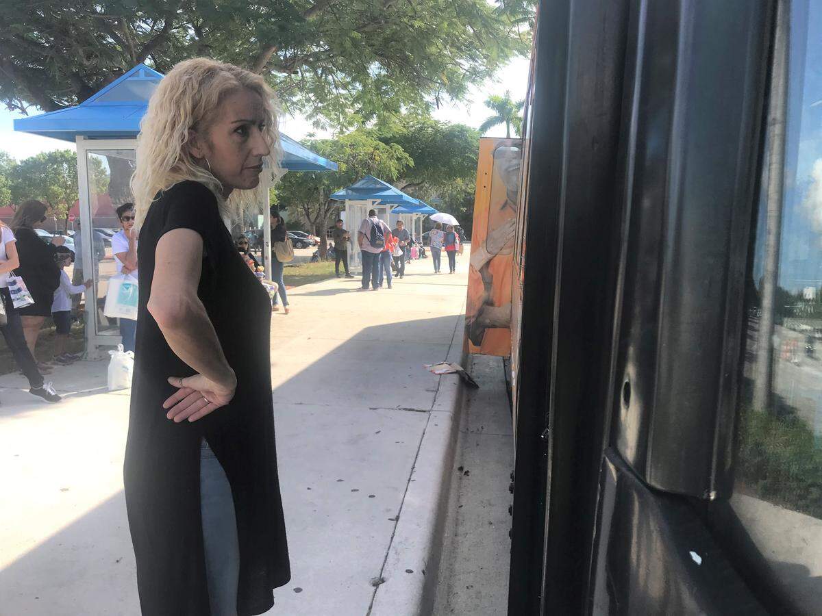 Monica Rodriguez asks a Miami-Dade bus driver when he can let her board for the trip home on Tuesday, Nov. 14, 2019, to Kendall from her job at the Dolphin Mall.