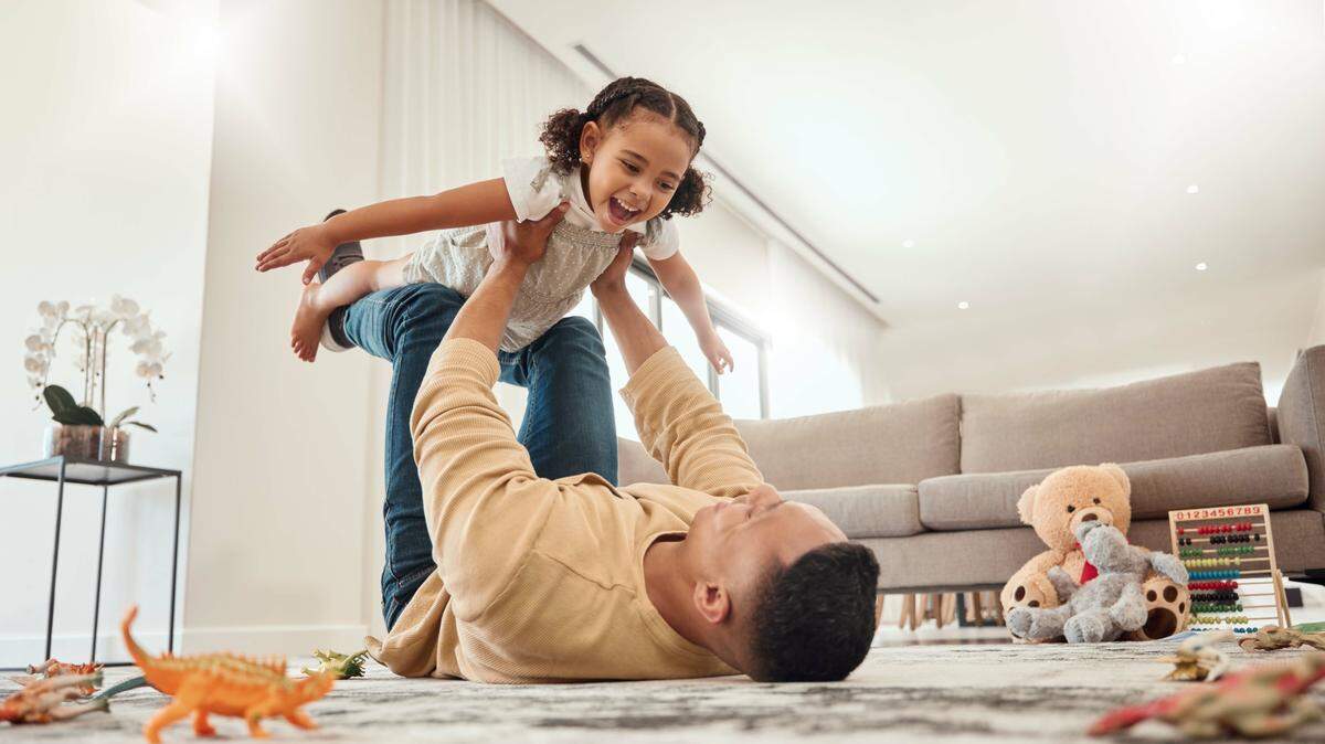 father daughter play airplane